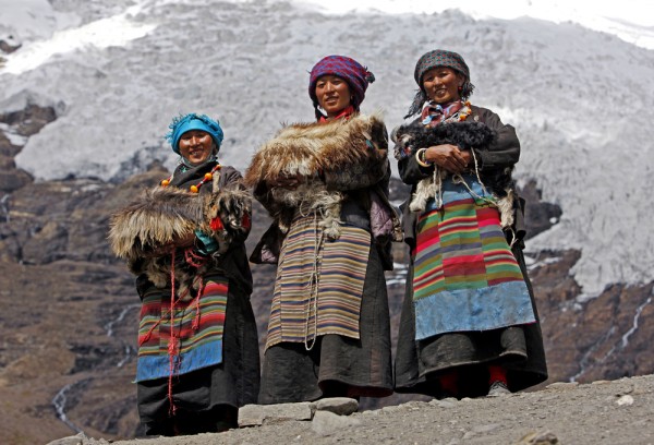 Three Tibetan women in traditional dresses