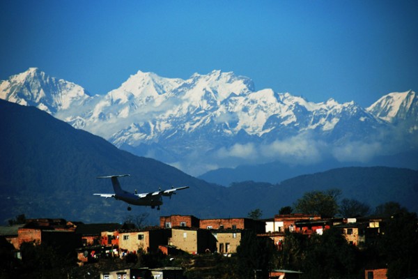 Plane Landing at Airport in Kathmandu with Himalayas mountains in background
